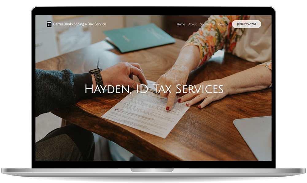 A laptop screen displays a website for Hayden, ID Tax Services, showing two people reviewing a document at a wooden desk.